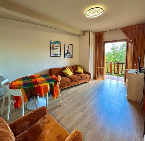 a living room with a couch and a table at NWT Roccaraso - Casa Vacanze in Roccaraso