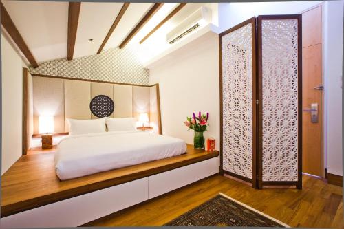 a bedroom with a bed and a large window at The Sultan in Singapore