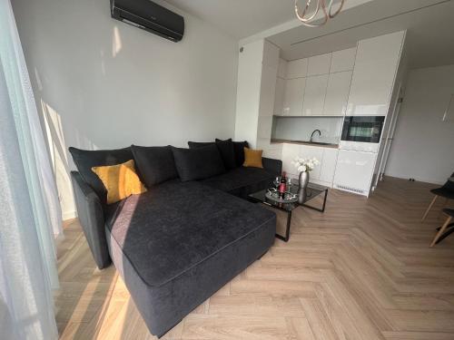a living room with a couch and a table at Horizon Park 33 Boszkowo in Boszkowo