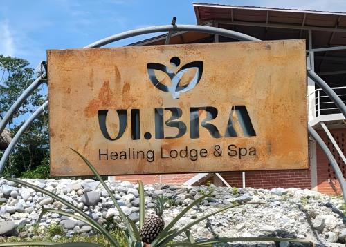 a sign for a healing lodge and spa at Vibra Healing Lodge y Spa in Teniente Hugo Ortiz