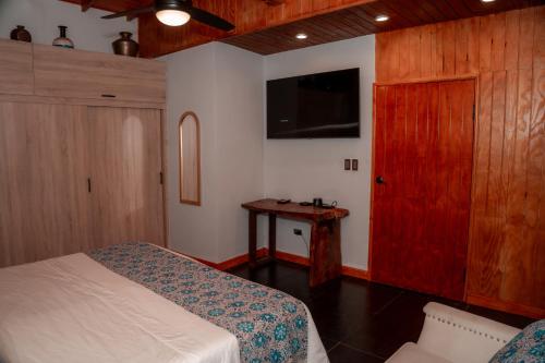 a bedroom with a bed and a red cabinet at Star Apple Inn in San Andrés