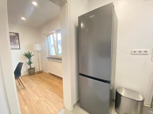 a kitchen with a stainless steel refrigerator in a room at Lux Apartment near Frankfurt! in Mörfelden-Walldorf