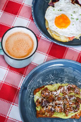 a table with two plates of food and a cup of coffee at Casa Ande Hotel boutique in Villa de Leyva