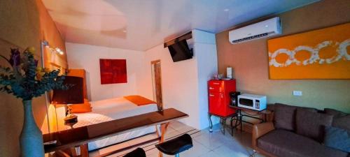 a small bedroom with a bed and a couch at Suite 607 Ciudad jardín San Miguel A in San Miguel