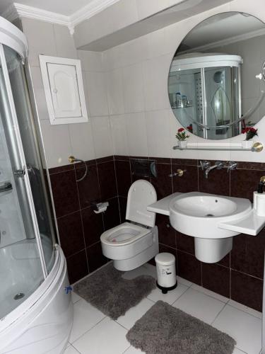 a bathroom with a toilet and a sink and a mirror at Une pépite avec vue panoramique playa, Tanger in Oulad Akkou