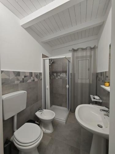 a bathroom with a toilet and a shower and a sink at Case Victoria - Mamalu in Lampedusa