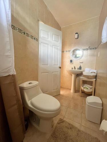 a bathroom with a white toilet and a sink at Yuxtal in Azcorra