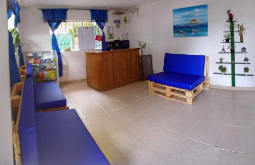 Casa Hotel Marly في سانتا مارتا: غرفة لعب مع زحليقة وكرسي أزرق