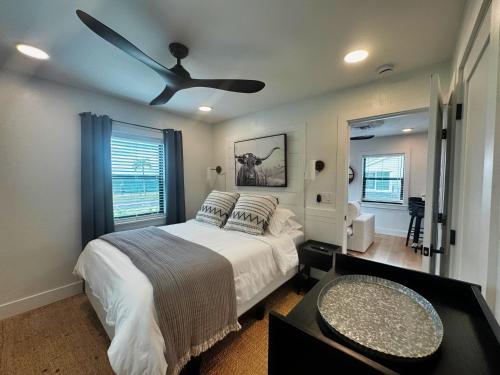 a bedroom with a bed with a ceiling fan at Walk to Best Eats and Shops and Stay in Style in Fort Myers