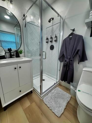 a bathroom with a shower and a sink at Walk to Best Eats and Shops and Stay in Style in Fort Myers