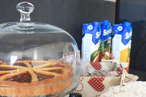 a cake in a glass dish on a table at Terrazzi in Fiore in Alghero