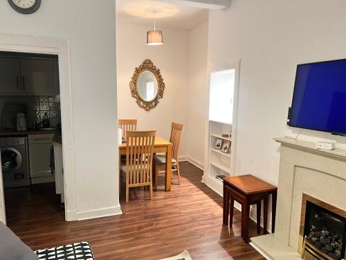a living room with a fireplace and a dining room at Royal Apartments Edinburgh in Edinburgh