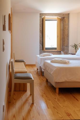 a room with three beds and a chair and a window at Real Villa I by Mycelia in Real
