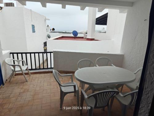 a table and chairs on a balcony with the ocean at Cabo house in Cabo Negro