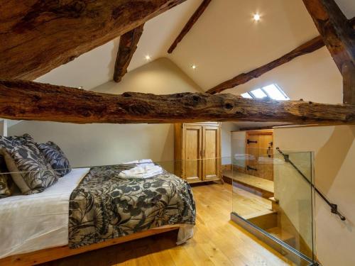 a bedroom with a bed in a room with wooden ceilings at 1 Bed in Hawkshead Village LLH18 in Hawkshead