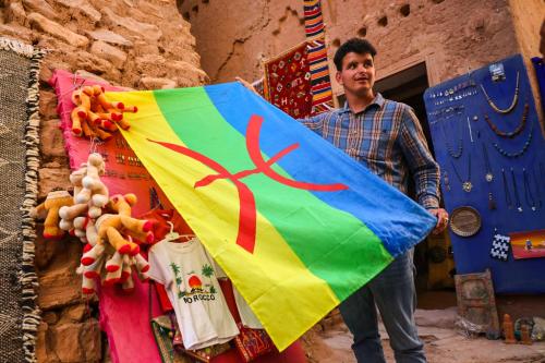 a man is holding a colorful kite at Land of dreams in Nkob