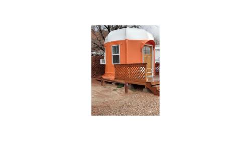 an orange tiny house sitting on a bench at Crazy Horse - APT 1 in Kanab