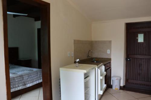 a small kitchen with a sink and a refrigerator at Pousada do sobrado in Bagé