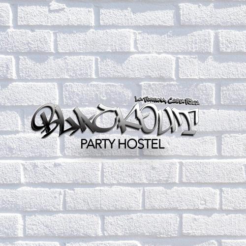 a sign for a party hostel on a white brick wall at Blackout Hostel in Fortuna