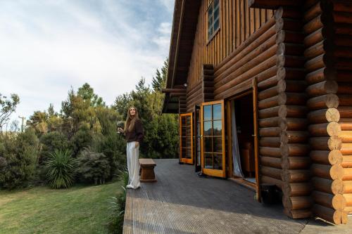 a woman standing on the porch of a house at Lyford Luxury Escape - ML21963 in Mt Lyford