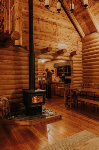 a log cabin with a stove in a room at Lyford Luxury Escape - ML21963 in Mt Lyford