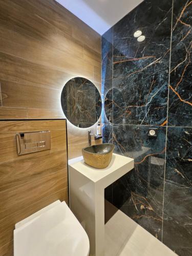 a bathroom with a bowl sink and a toilet at Eleni Beach Apartment in Stalís