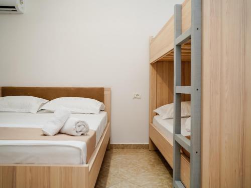a bedroom with two bunk beds and a ladder at Deve Mar Hotel in Borsh