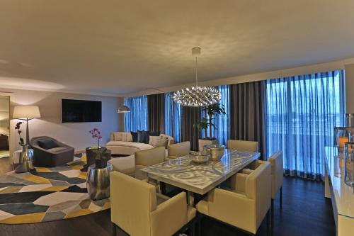 a dining room and living room with a table and chairs at InterContinental At Doral Miami by IHG in Miami