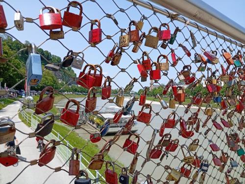 a fence with lots of locks on it at arte vida boutique guesthouse in Salzburg