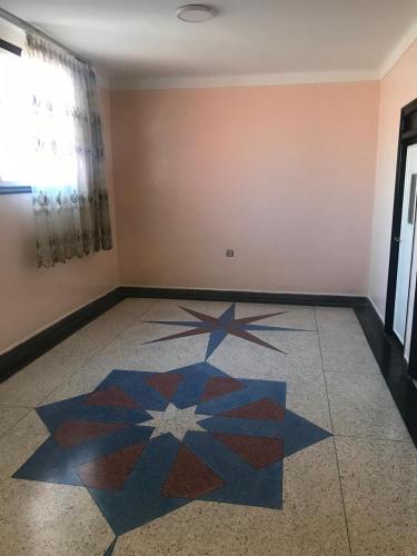 an empty room with a floor with a star pattern at Dar aziz in Essaouira