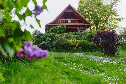 a house in the middle of a field of flowers at Slow House Gaładuś in Radziucie