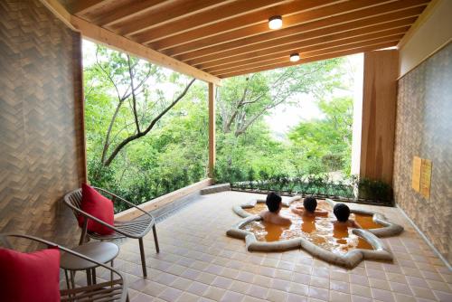 two children sitting on the patio of a house at Arima Onsen Motoyu Ryuusenkaku in Kobe