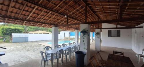 a group of chairs sitting under a wooden ceiling at A few kilometers from banana plantations in Belém