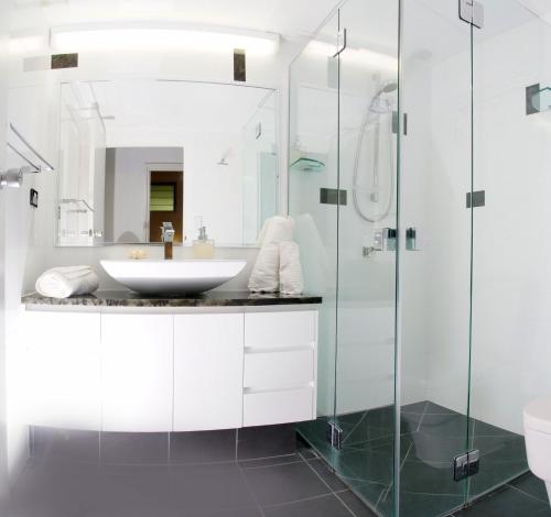 a bathroom with a sink and a shower at Poinciana 112 in Hamilton Island