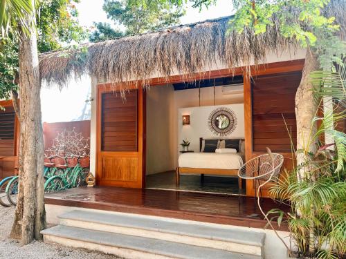 a bedroom in a resort with a bed in it at Mimosa Tulum in Tulum