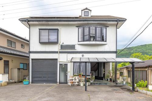 a white house with a garage at Raku Raku in Nikko