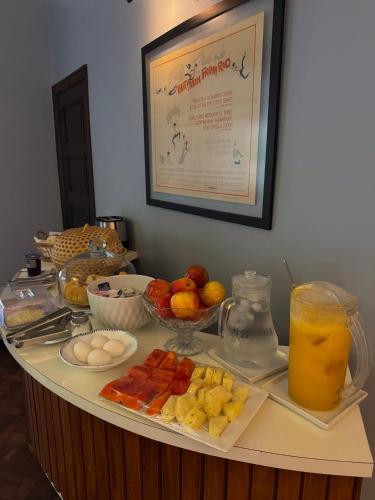 a buffet with fruit and a drink on a table at RARO Ipanema Boutique Hotel in Rio de Janeiro