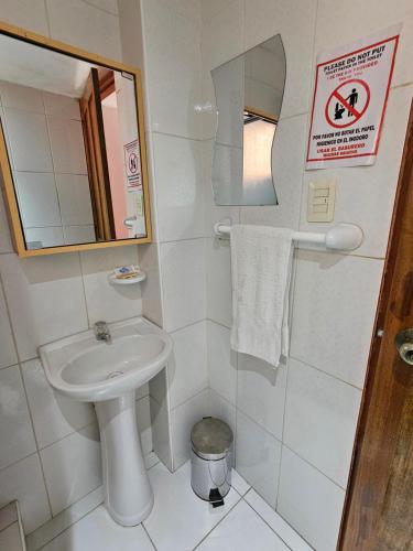 a small bathroom with a sink and a mirror at SAMAY WASI b&b in Cusco