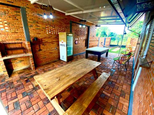 a patio with a wooden table and a bench at Cabaña Premium Yvyja de La Mala Junta in Atyrá