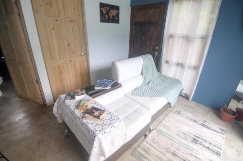 a living room with a white couch and a table at Tiny Bosque del Barro in Barrio Jesús