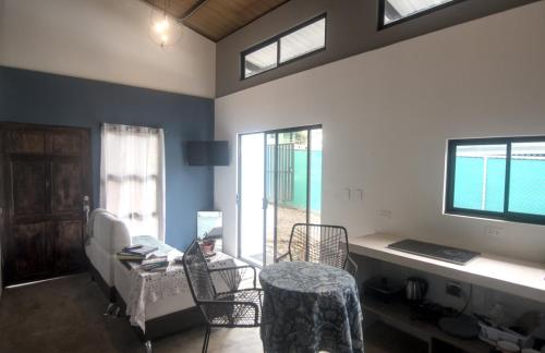 a room with a bed and a table and chairs at Tiny Bosque del Barro in Barrio Jesús