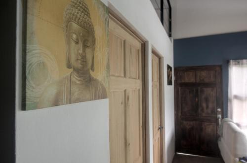 a painting of a statue on a wall in a room at Tiny Bosque del Barro in Barrio Jesús