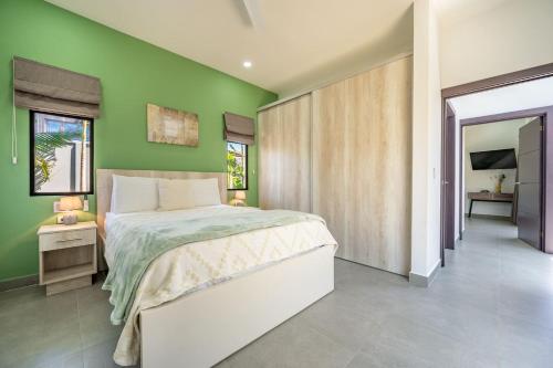 a bedroom with green walls and a large bed at Casa Encanto -beautiful Home in Potrero