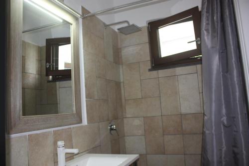 a bathroom with a sink and a mirror and a shower at Casetta Minghitto Relaxing rooms in Capri in Anacapri