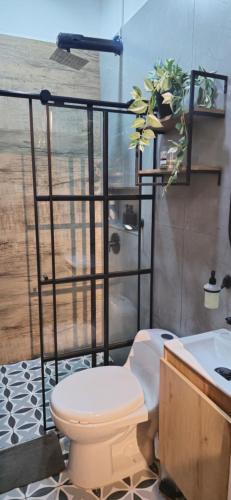 a bathroom with a toilet and a sink at Apartamento Envigado wifi 700 mb in Envigado