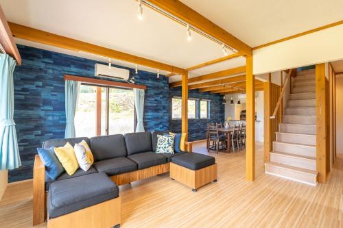 a living room with a couch and a table at 新築!一棟貸切ヴィラ Sea Garden Ishigaki 提携レンタカー割引有り! in Ishigaki Island