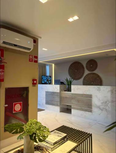 a lobby of aarmaarma store with a potted plant at Buenos Ayres Flats, Cabo Branco 1qto cozinha completa in João Pessoa