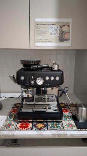 a coffee maker sitting on a counter in a kitchen at Modern Beach Haven with Hot tub and Sauna in Salamander Bay