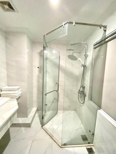 a bathroom with a shower with a glass door at Asean Hotel in Hải Dương