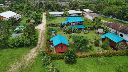 an aerial view of a house with blue roofs at Lucky Bungalow in Khao Lak